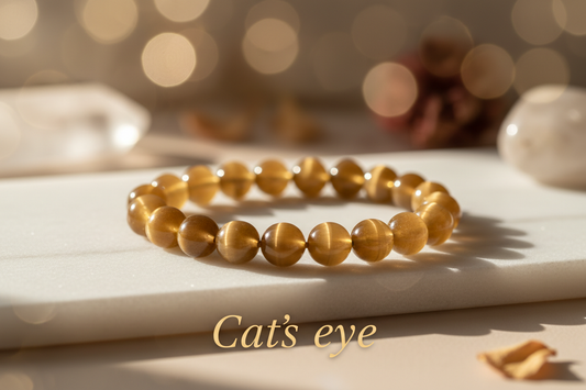 Catseye single bracelet in 8mm round beads on marble flat stand with soft holistic background with Cats eye written