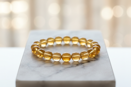 citrin crystal bracelet 8mm round beads on marble flat stand in the middle with holistic soft background 