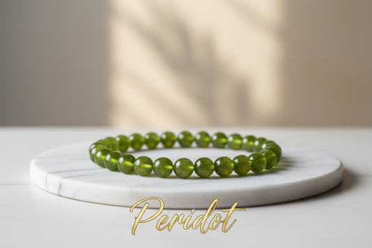 Peridot crystal single bracelet in 8mm round beads on marble flat stand with soft holistic background with Peridot written