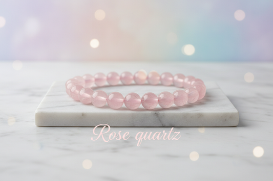 Rosequartz crystal single bracelet in 8mm round beads on marble flat stand with soft holistic background with Rose quartz written