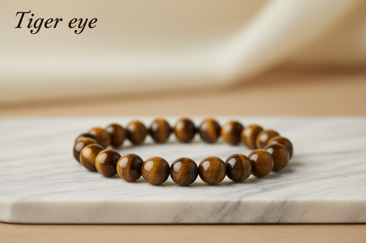 Tiger eye single bracelet 8mm  round beads on marble flat stand in the middle with holistic soft background with Tiger eye written
